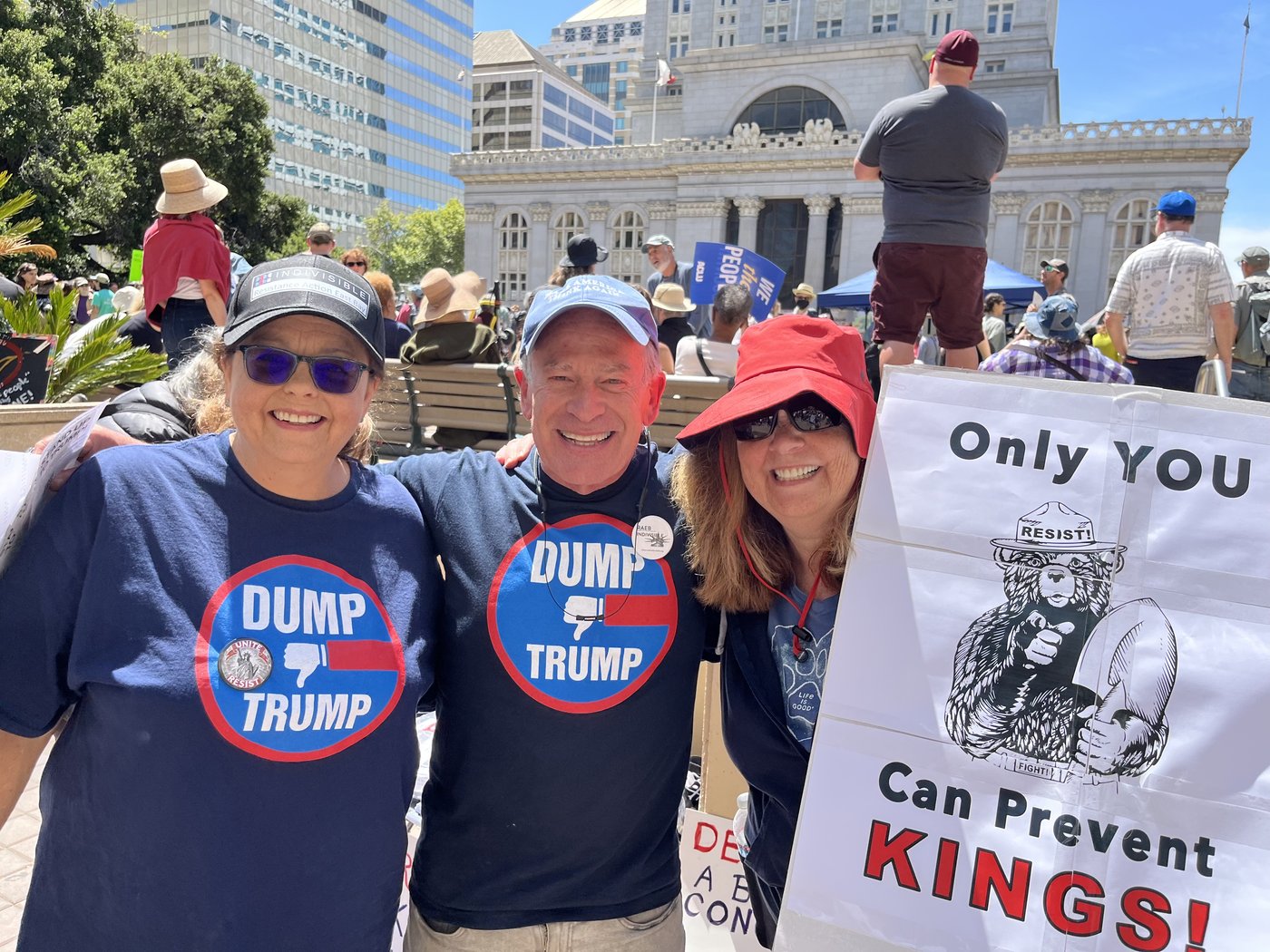 RAEB Indivisible members at a No Kings march in Oakland holding Dump Trump and Can Prevent Kings signs